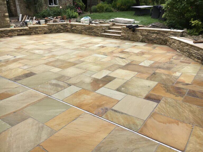 Sandstone paving and stone wall